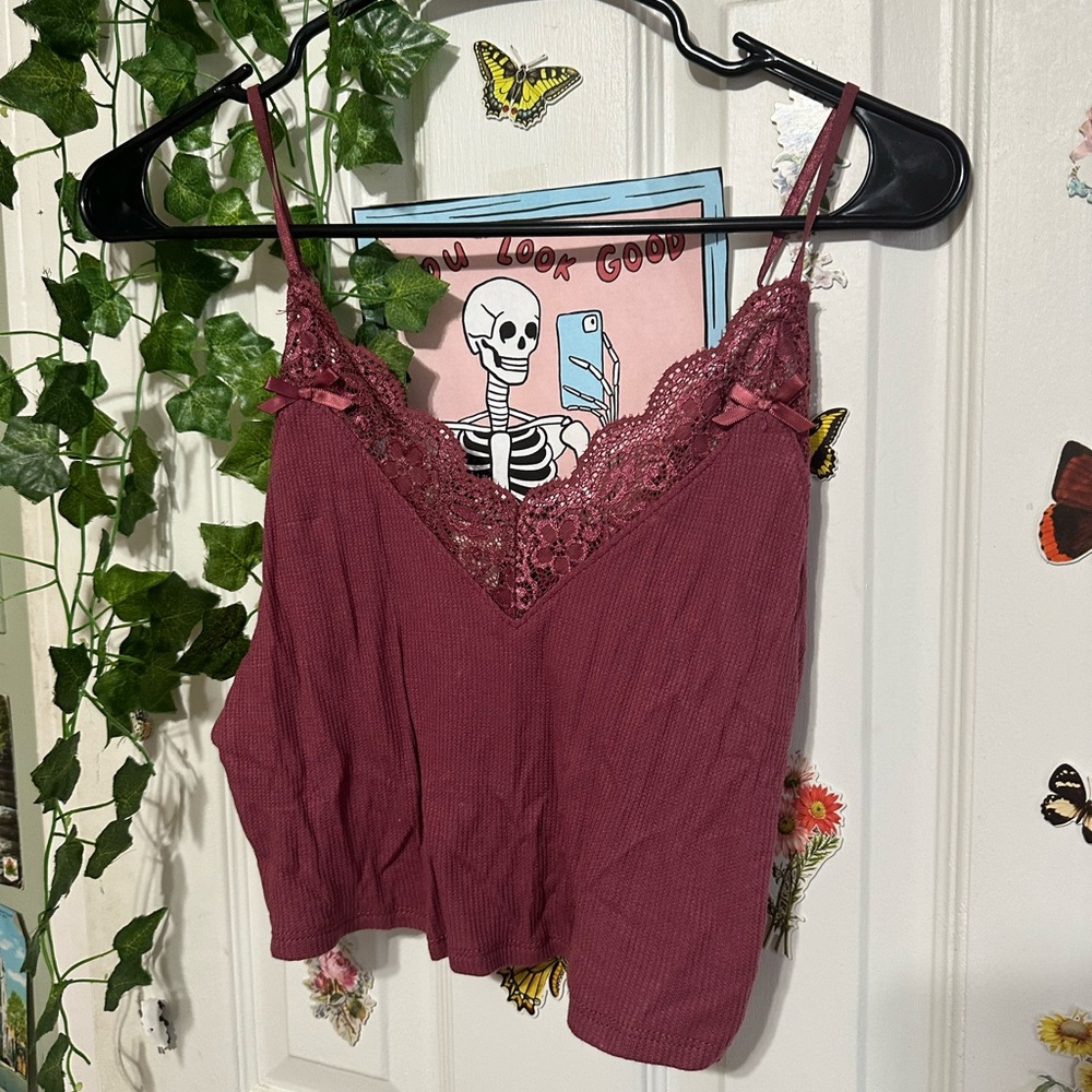 A lace tank top with some bows on it